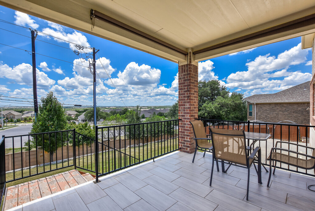 a view of a balcony with furniture