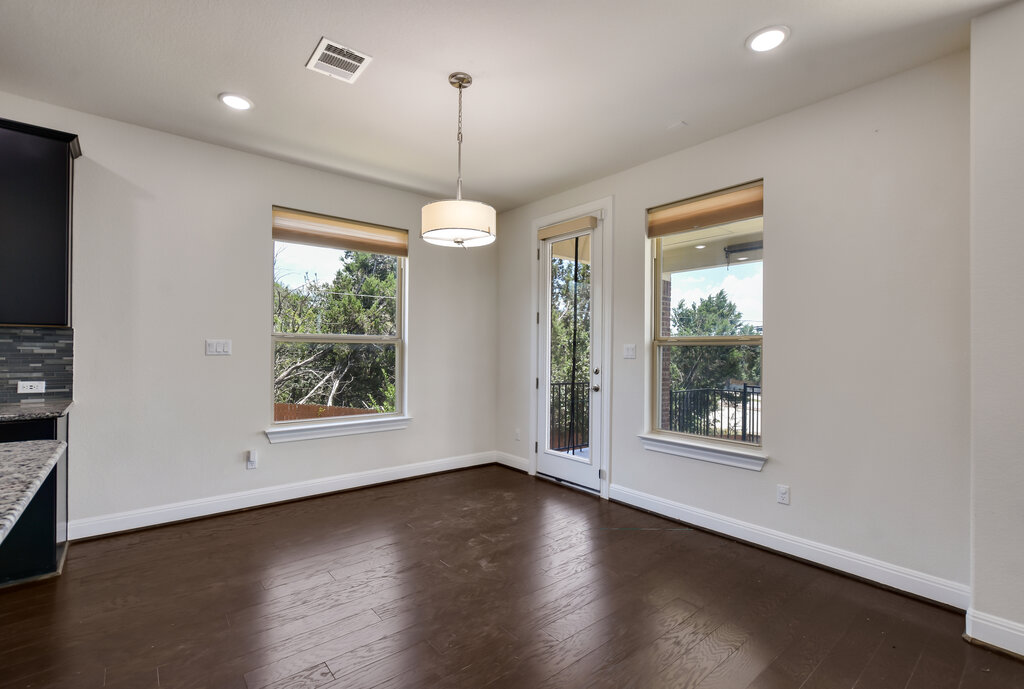 2521 Blended Tree Ranch Drive Leander, TX 78641 - Photo 15 of 40 an empty room with wooden floor windows and outdoor view
