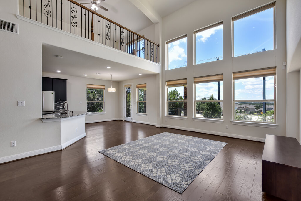 2521 Blended Tree Ranch Drive Leander, TX 78641 - Photo 19 of 40 a view of an entryway with wooden floor and windows