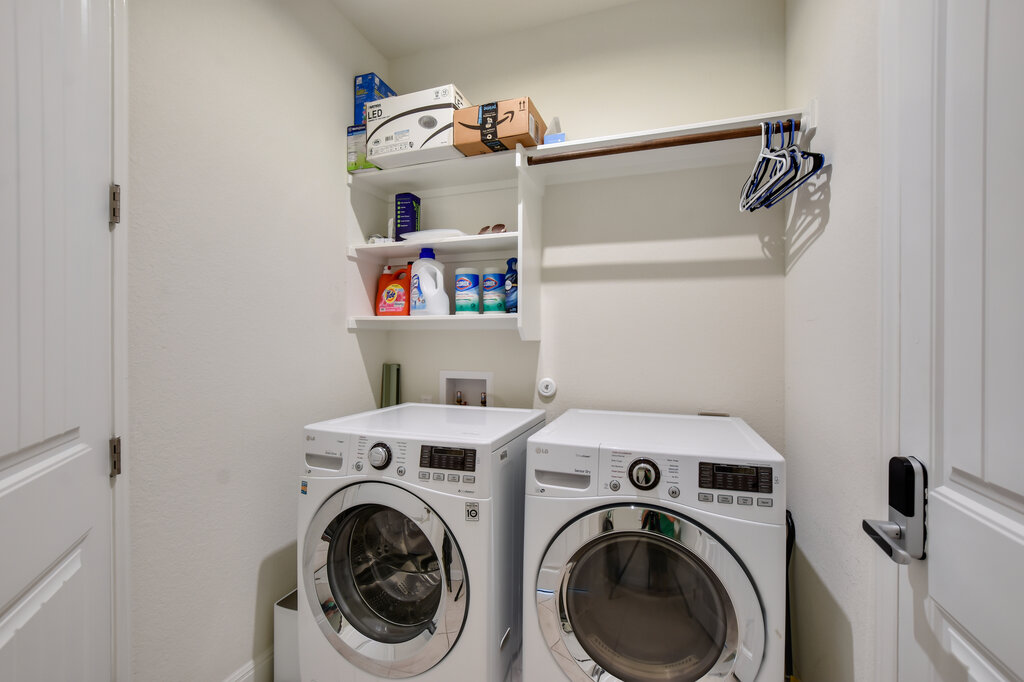 2521 Blended Tree Ranch Drive Leander, TX 78641 - Photo 21 of 40 a view of storage and utility room with racks on the wall