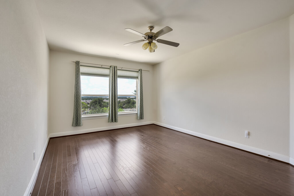2521 Blended Tree Ranch Drive Leander, TX 78641 - Photo 22 of 40 wooden floor in an empty room with a window