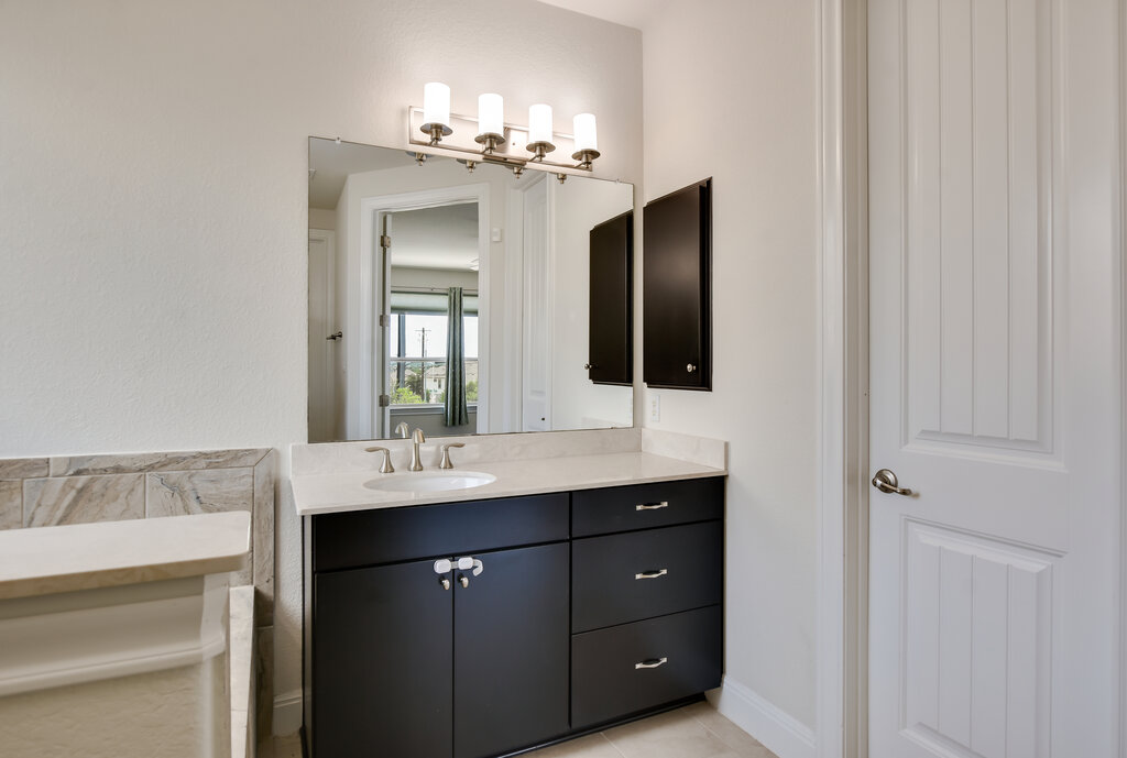 2521 Blended Tree Ranch Drive Leander, TX 78641 - Photo 26 of 40 a bathroom with a sink and a mirror