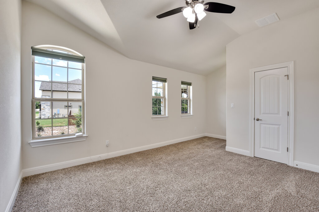 2521 Blended Tree Ranch Drive Leander, TX 78641 - Photo 35 of 40 an empty room with windows and chandelier fan