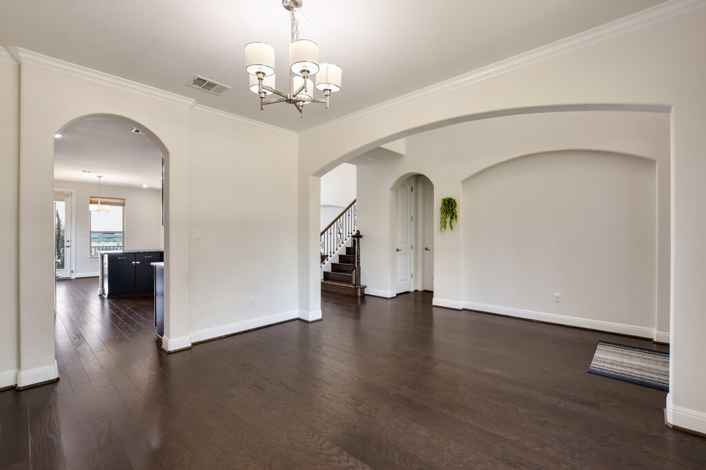 2521 Blended Tree Ranch Drive Leander, TX 78641 - Photo 10 of 40 a view of a hallway with wooden floor staircase and a living room