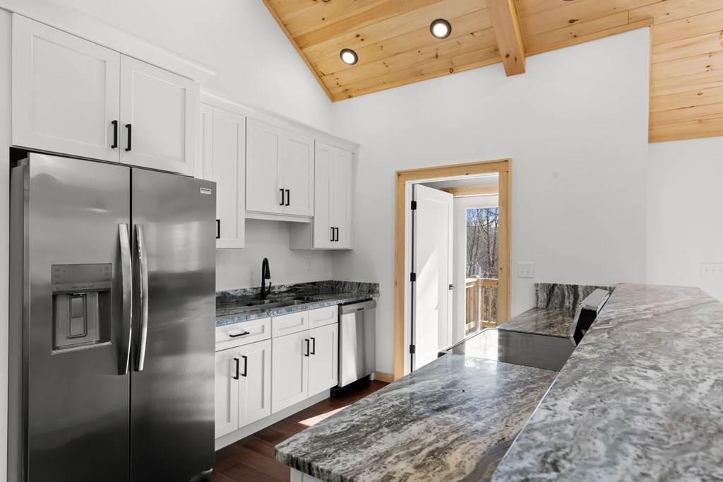 150 Williams Branch Drive Morganton, GA 30560 - Photo 14 of 28 a kitchen with stainless steel appliances granite countertop a refrigerator a stove and a sink with granite countertops