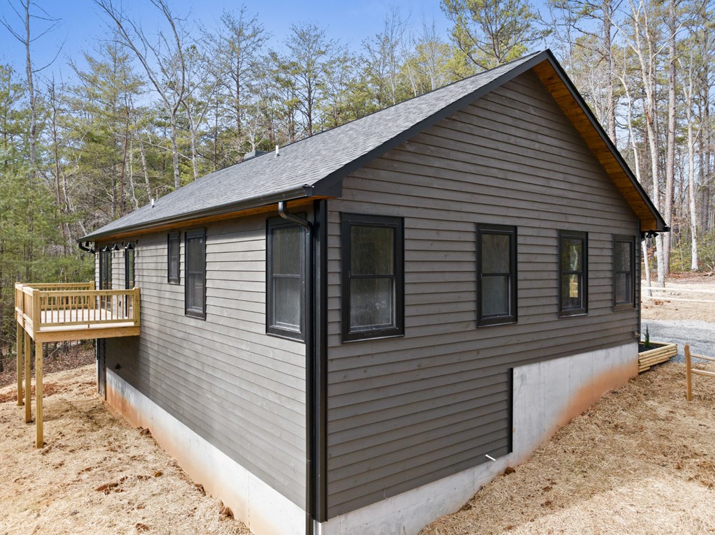 150 Williams Branch Drive Morganton, GA 30560 - Photo 26 of 28 a view of a white house with a small yard and large tree