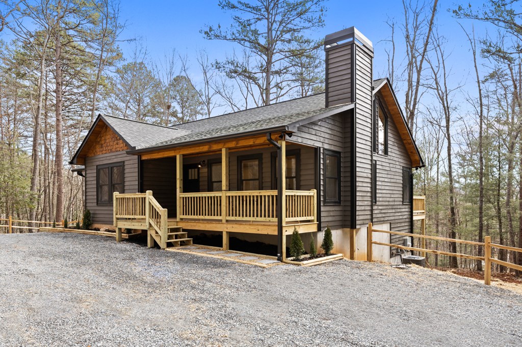 150 Williams Branch Drive Morganton, GA 30560 - Photo 4 of 28 a view of a house with a large window and wooden fence