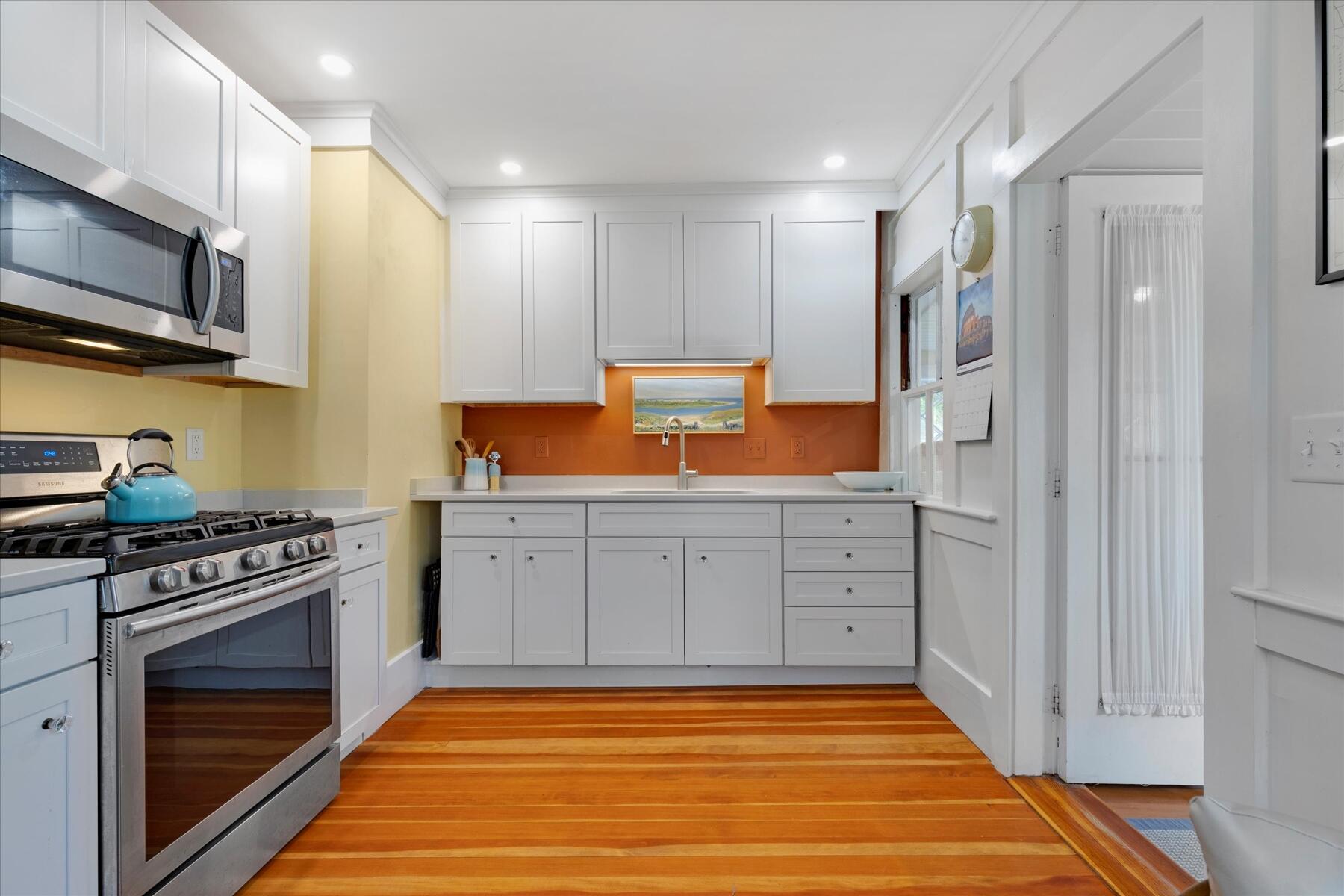 21 Quaker Road East Sandwich, MA 02537 - Photo 24 of 43 a kitchen with stainless steel appliances granite countertop a stove a sink and a refrigerator