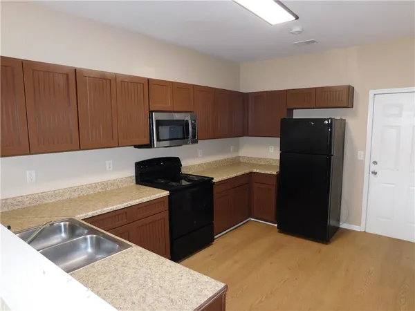 a kitchen with a refrigerator and a sink