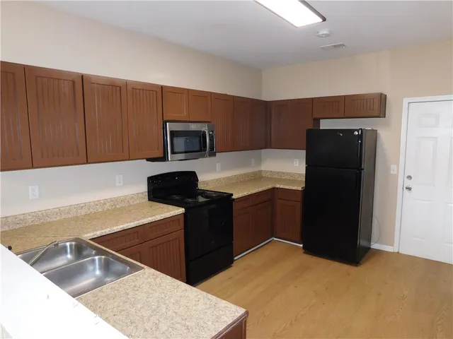 a kitchen with a refrigerator and a sink