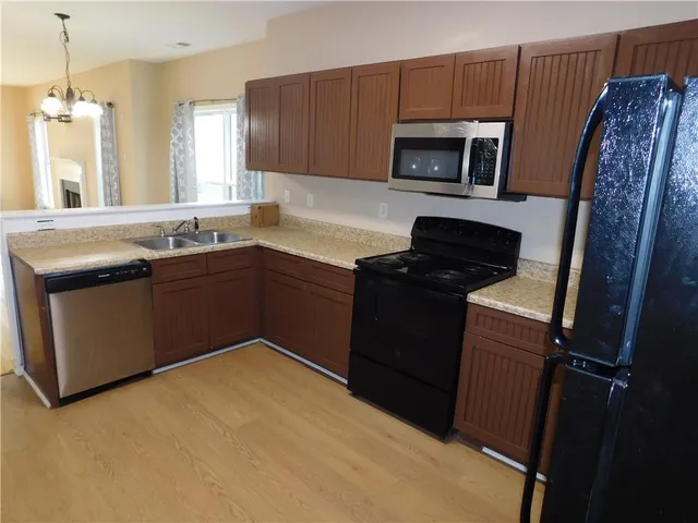 a kitchen with a sink stove and microwave