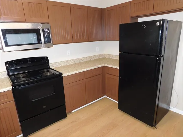 a kitchen with a refrigerator stove and microwave