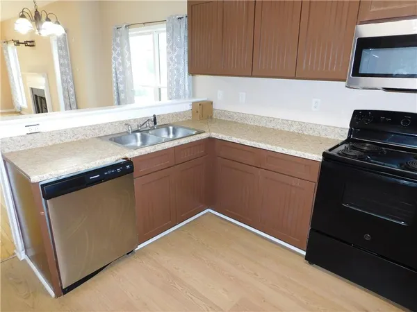 a kitchen with a sink stove and cabinets