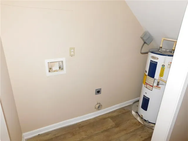 a view of a room with wooden floor and white wall
