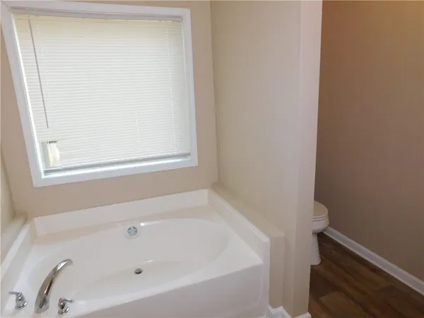 a white bath tub sitting next to a window