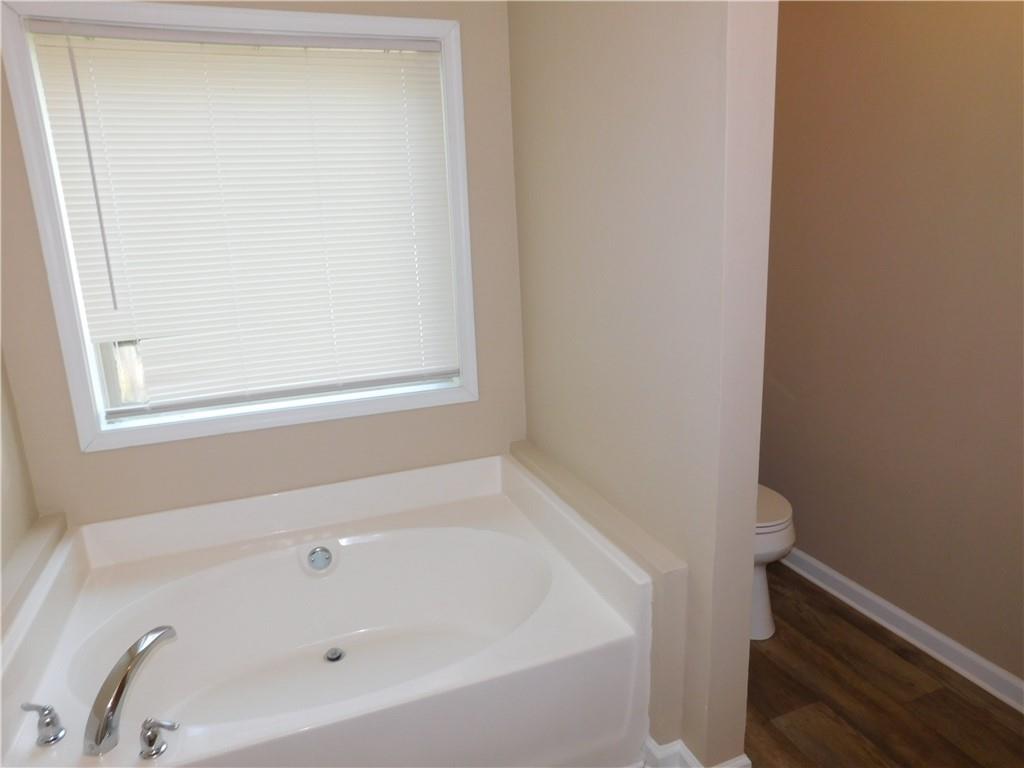 1005 Linam Avenue Southeast Atlanta, GA 30315 - Photo 20 of 29 a white bath tub sitting next to a window