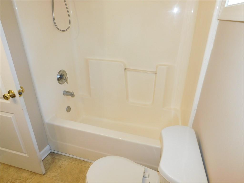 1005 Linam Avenue Southeast Atlanta, GA 30315 - Photo 26 of 29 a bathroom with a toilet and a bath tub