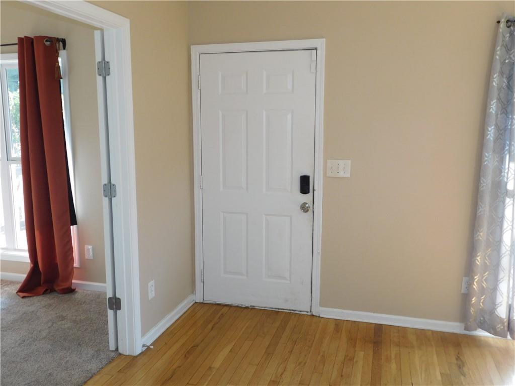 1005 Linam Avenue Southeast Atlanta, GA 30315 - Photo 5 of 29 a view of a room with wooden floor and a bathroom