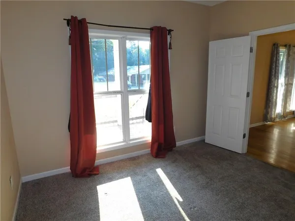 a view of empty room with floor to ceiling window