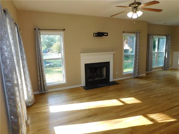 a view of a livingroom with a fireplace and window