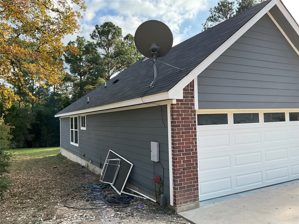 239 Old Firetower Road Bastrop, TX 78602 - Photo 12 of 39 a backyard of a house with wooden fence and large tree