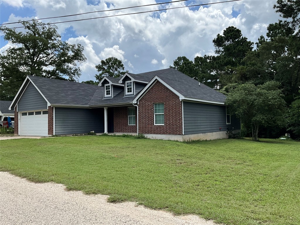 239 Old Firetower Road Bastrop, TX 78602 - Photo 2 of 39 a front view of a house with a garden