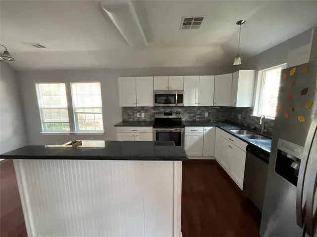a view of a roof with wooden floor and fence