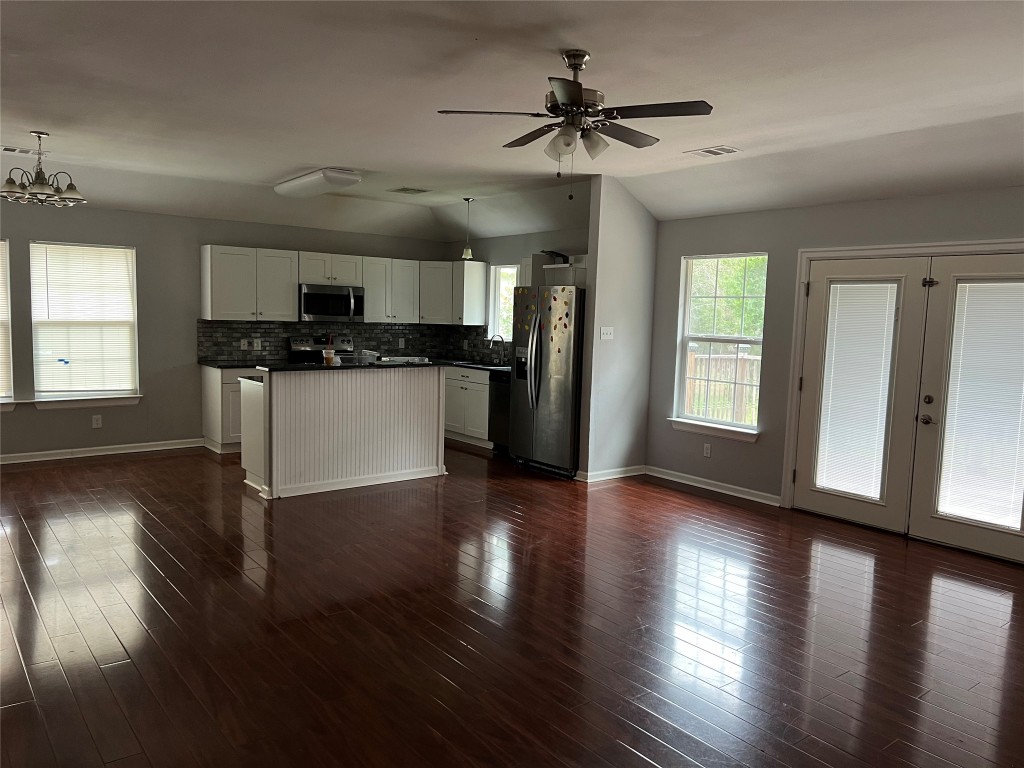 239 Old Firetower Road Bastrop, TX 78602 - Photo 38 of 39 a kitchen with stainless steel appliances granite countertop a sink cabinets and wooden floor
