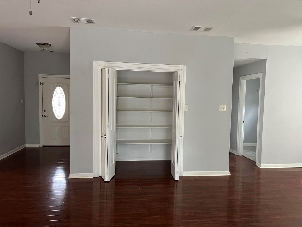 239 Old Firetower Road Bastrop, TX 78602 - Photo 8 of 39 an empty room with wooden floor mirror and windows
