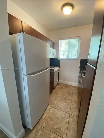 a kitchen with sink cabinets and window