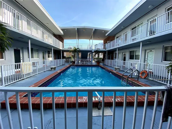 a view of a house with pool and wooden floor