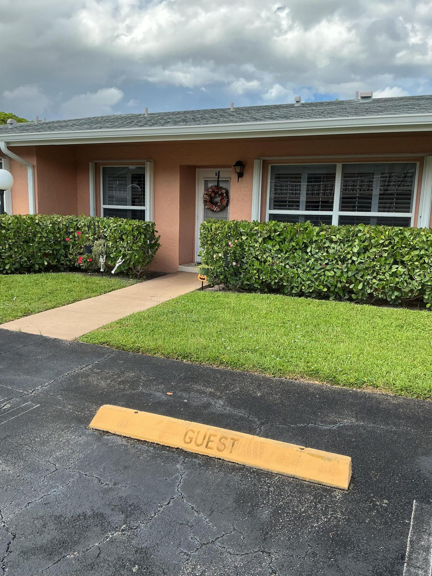 a view of a house with a yard and a garage