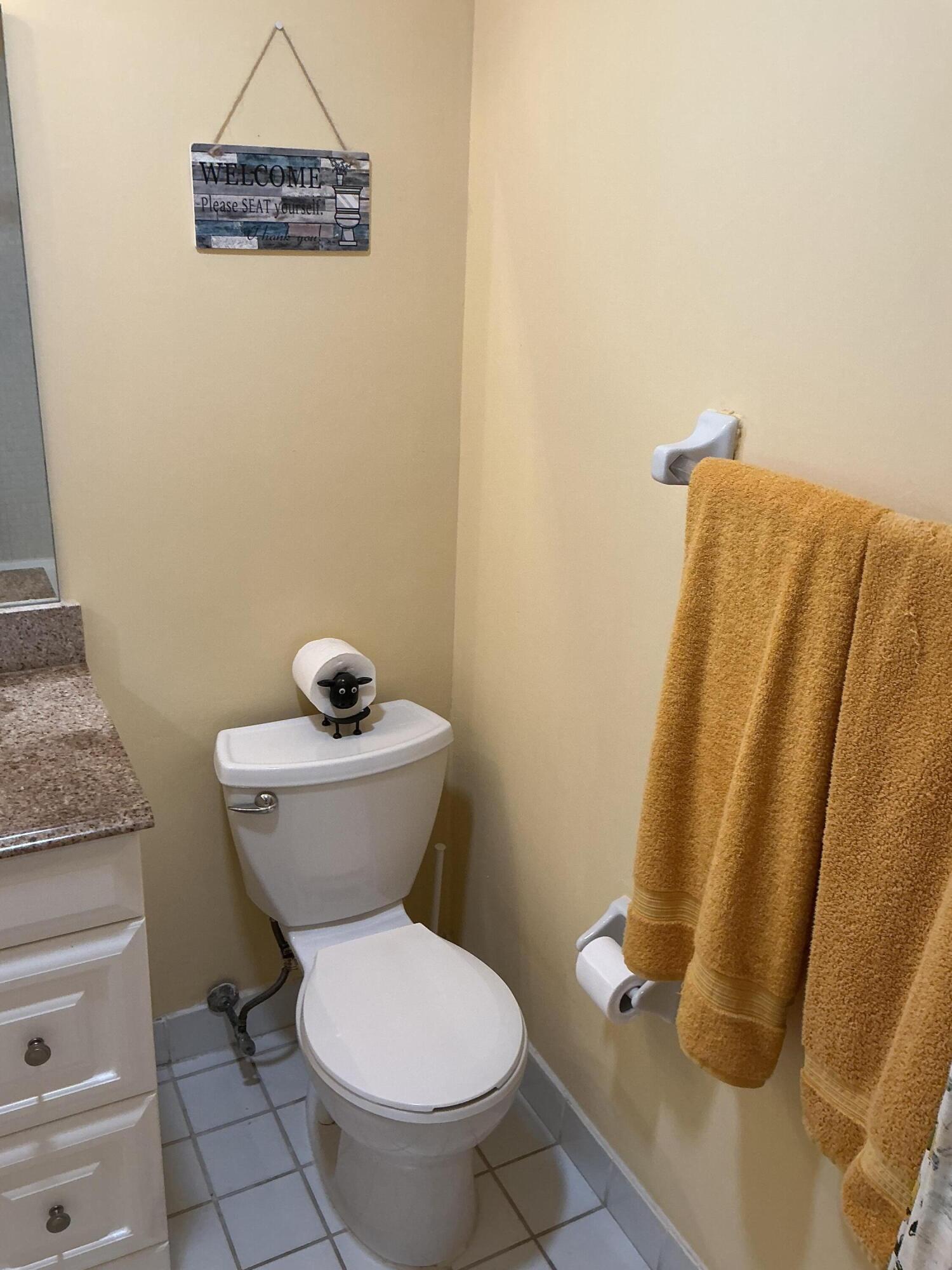 1580 Northwest 18th Avenue, Unit 98B Delray Beach, FL 33445 - Photo 12 of 16 a bathroom with a toilet and a sink