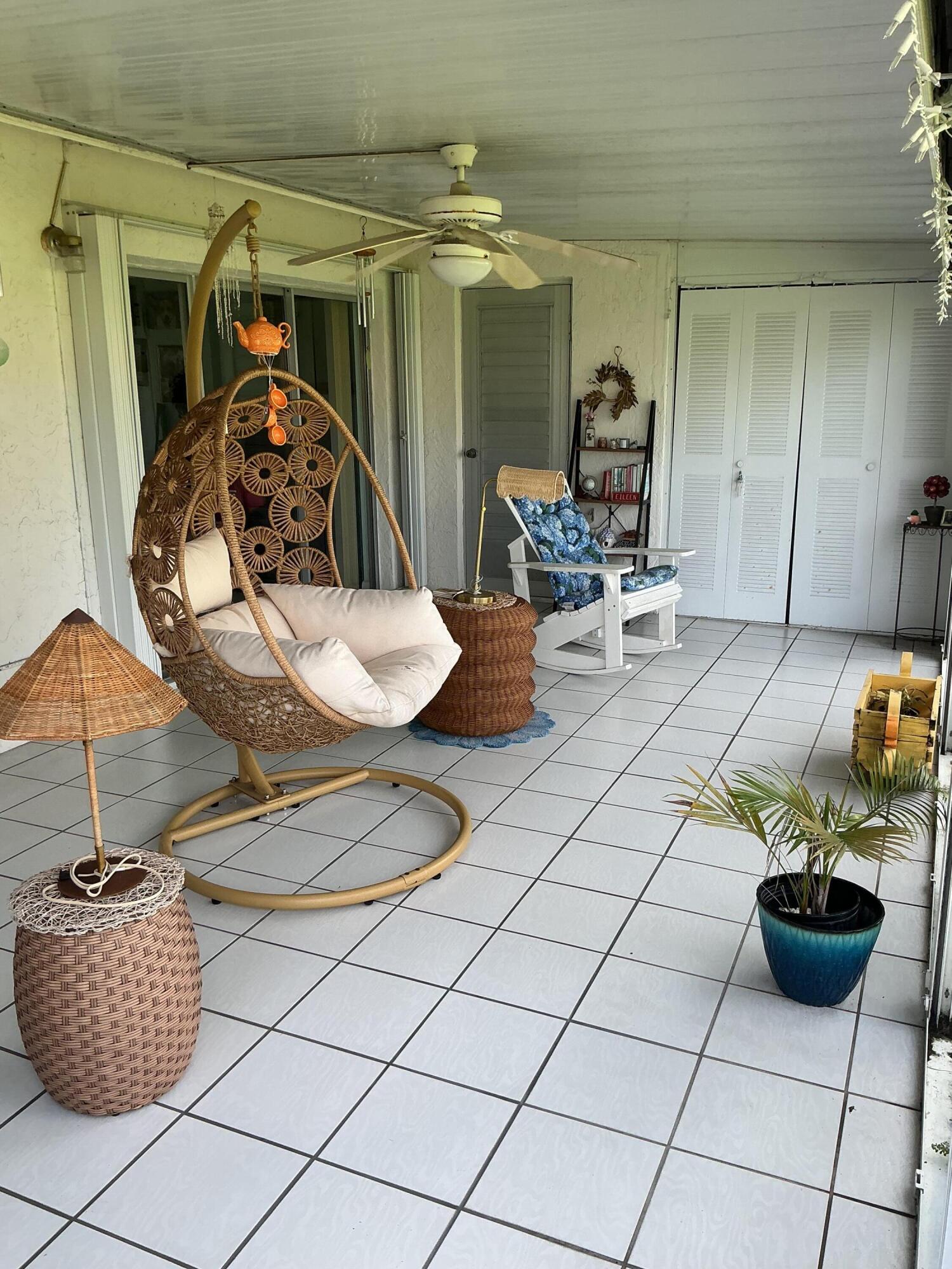 1580 Northwest 18th Avenue, Unit 98B Delray Beach, FL 33445 - Photo 13 of 16 a living room with furniture and chairs