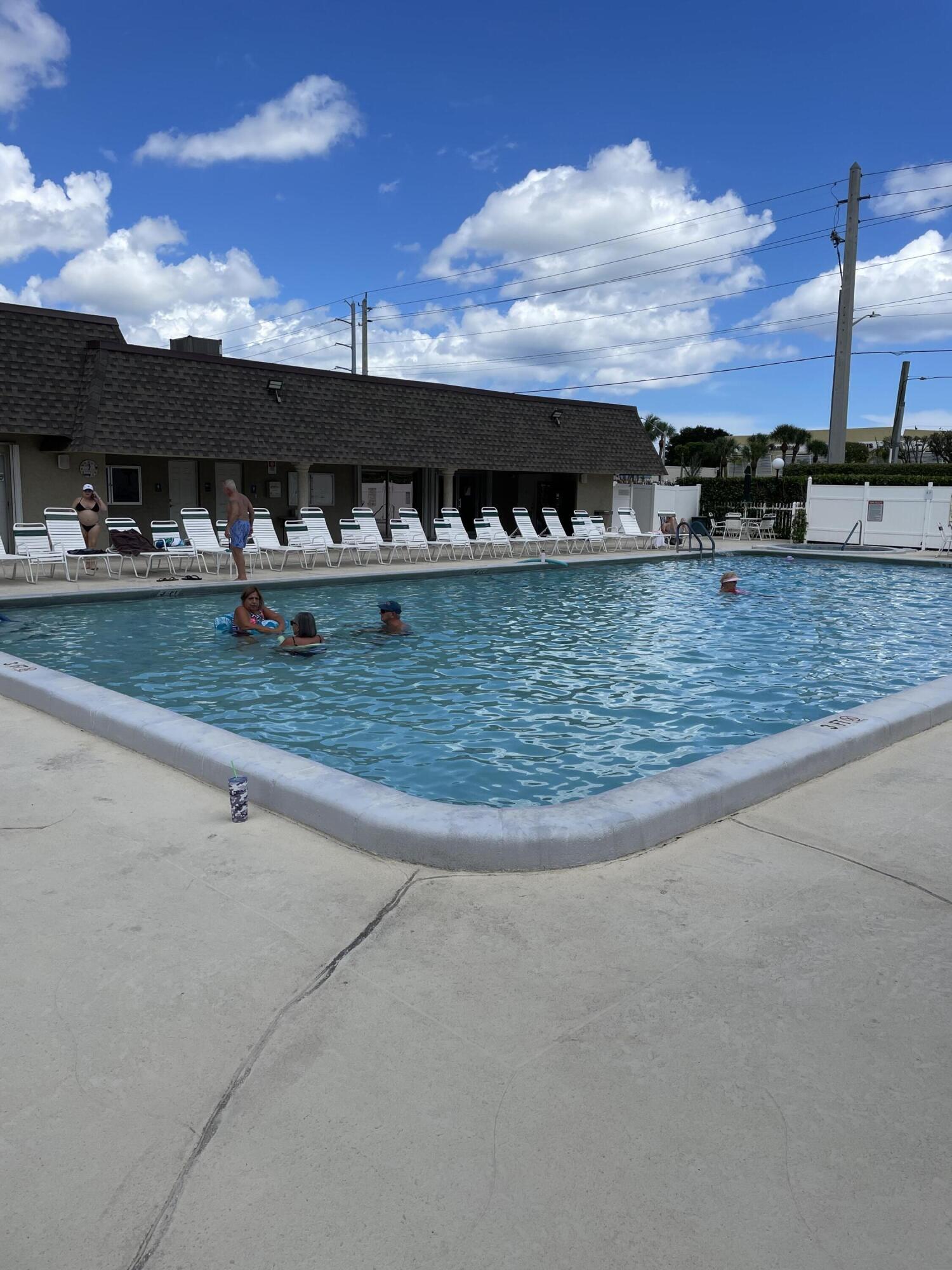 1580 Northwest 18th Avenue, Unit 98B Delray Beach, FL 33445 - Photo 15 of 16 front view of house with a yard