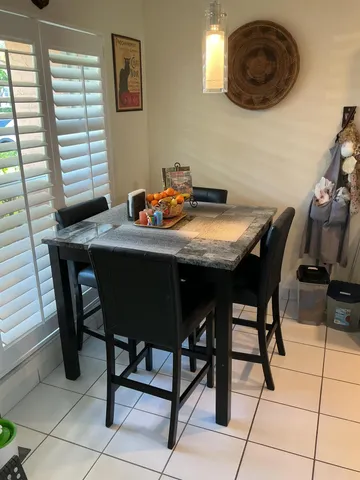 a view of a dining room with furniture and window