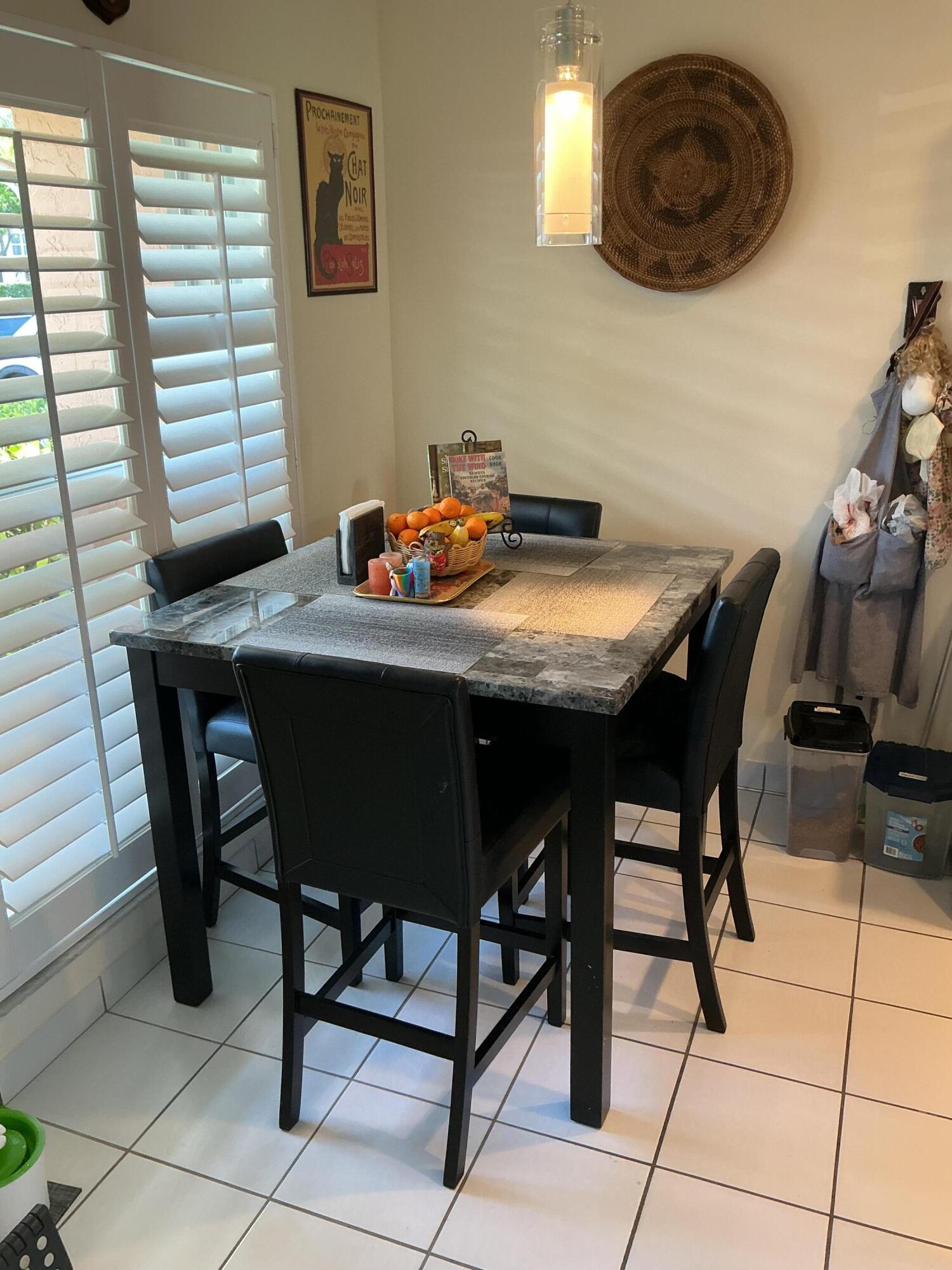 1580 Northwest 18th Avenue, Unit 98B Delray Beach, FL 33445 - Photo 2 of 16 a view of a dining room with furniture and window