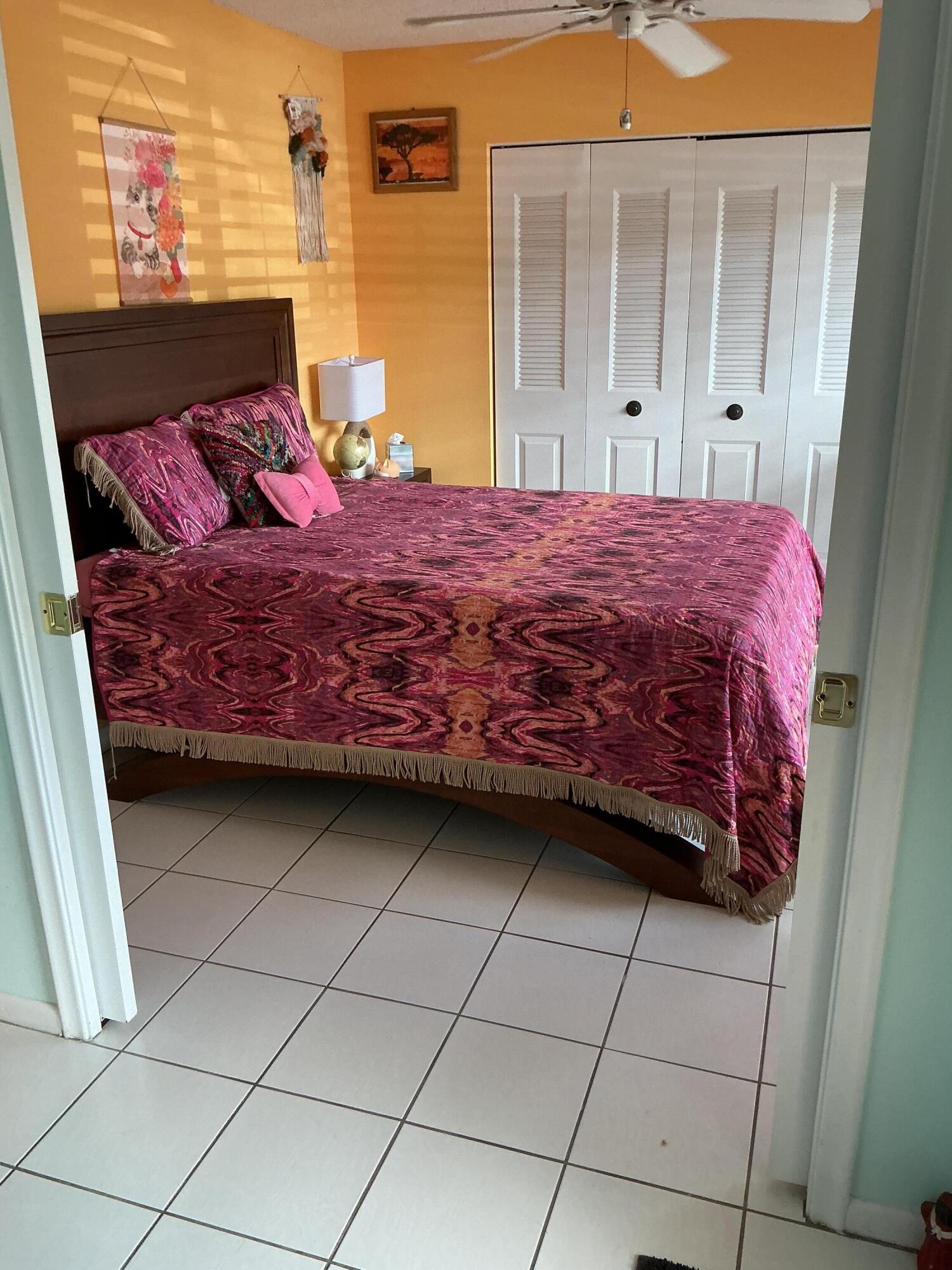 1580 Northwest 18th Avenue, Unit 98B Delray Beach, FL 33445 - Photo 4 of 16 a bedroom with a bed and a stove