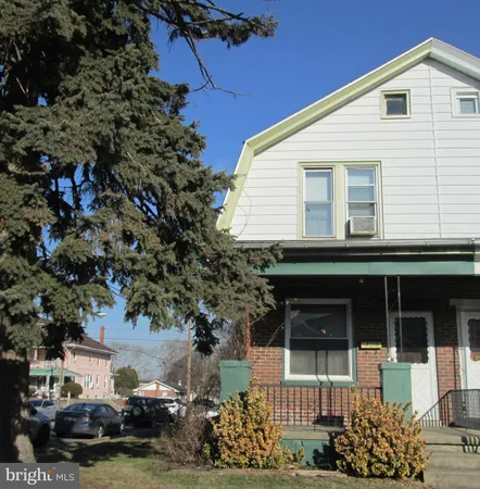 a view of a house with a garden and pathway