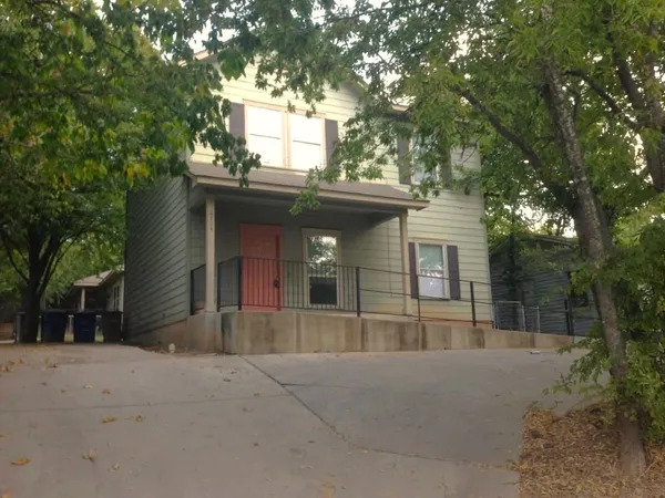 front view of a house with a trees