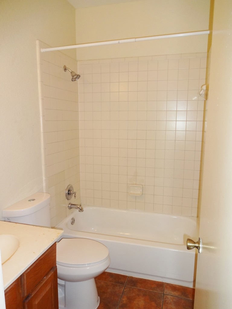 4704 Ledesma Road, Unit A & B Austin, TX 78721 - Photo 11 of 24 a bathroom with a bathtub shower sink vanity and toilet