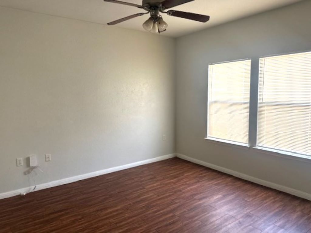 4704 Ledesma Road, Unit A & B Austin, TX 78721 - Photo 21 of 24 an empty room with wooden floor fan and windows