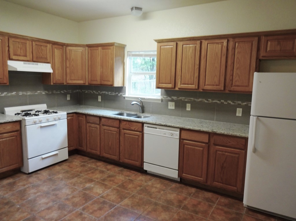 4704 Ledesma Road, Unit A & B Austin, TX 78721 - Photo 4 of 24 a kitchen with a sink a stove and cabinets