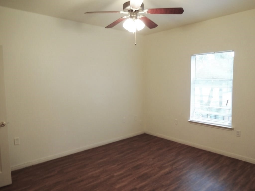 4704 Ledesma Road, Unit A & B Austin, TX 78721 - Photo 5 of 24 an empty room with wooden floor and windows
