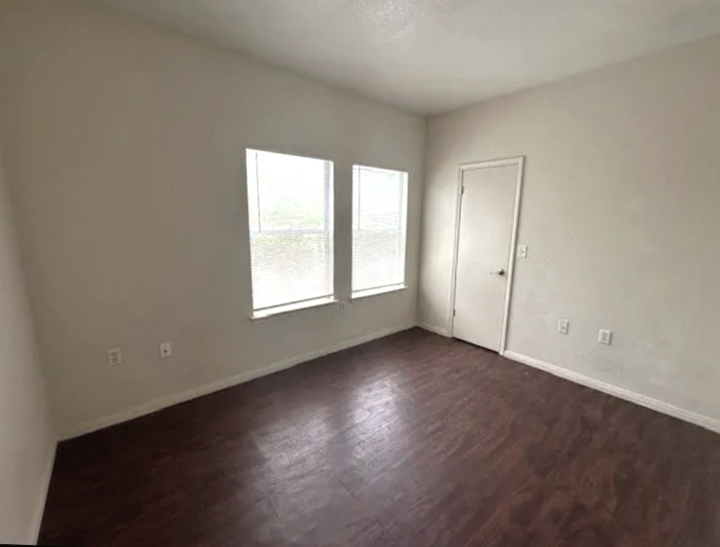 4704 Ledesma Road, Unit A & B Austin, TX 78721 - Photo 8 of 24 an empty room with wooden floor and windows