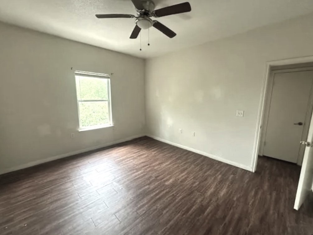 4704 Ledesma Road, Unit A & B Austin, TX 78721 - Photo 9 of 24 an empty room with wooden floor fan and windows
