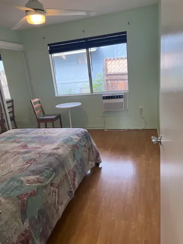 a bed sitting in a room next to a window