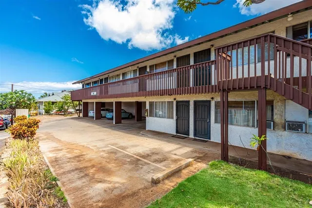 a front view of a house with a yard balcony