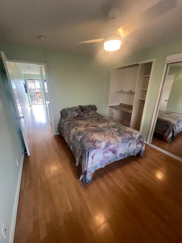 a bedroom with a bed and a mirror