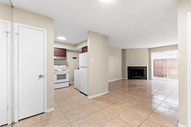 a view of a kitchen with refrigerator cabinets and an empty room